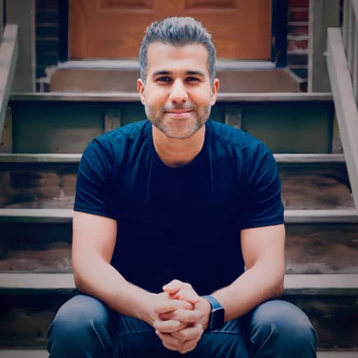 Alphan sitting on steps in front of a house