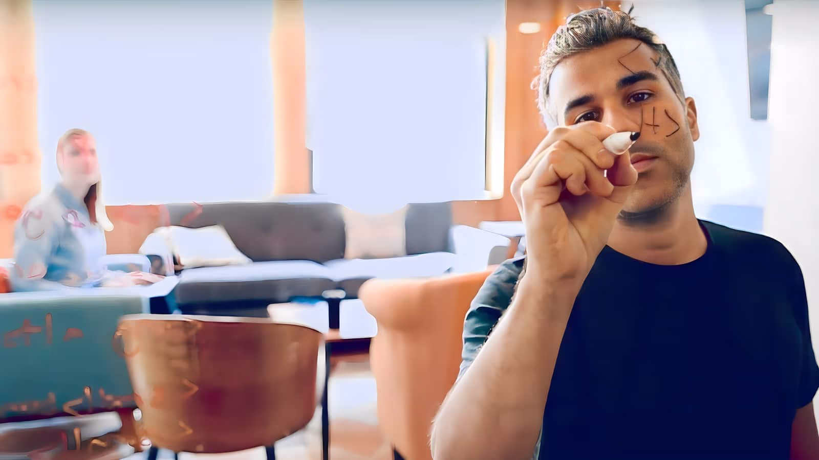 A photograph of Alphan Günaydın writing HTML